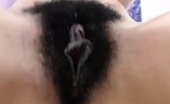 Curly brunette fingering her hairy pussy at bathroom